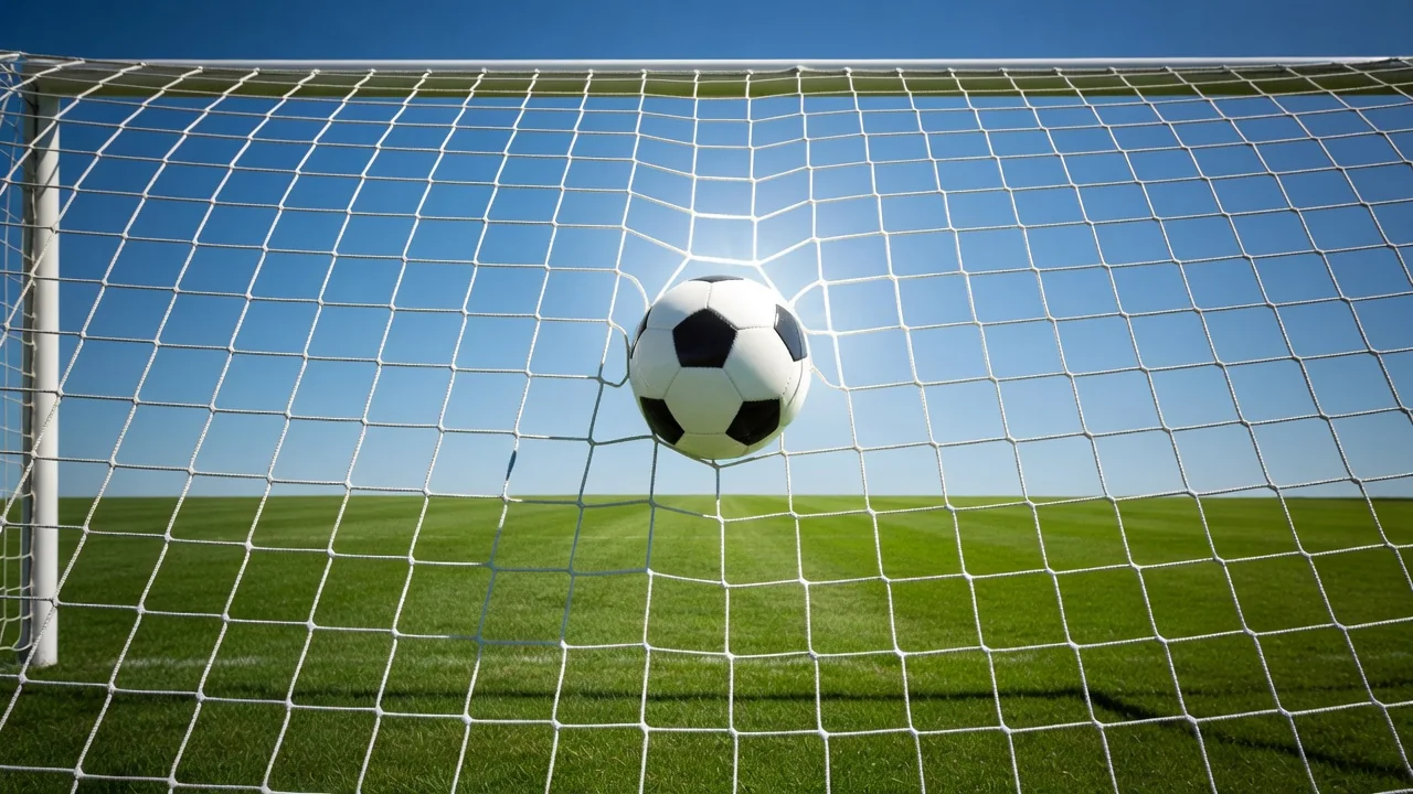 Soccer ball frozen inside the goal net, bright backlit mesh