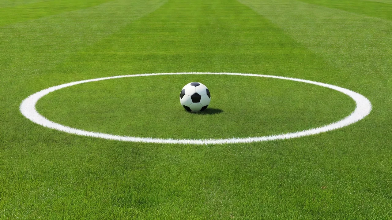 Classic black and white soccer ball on the center circle of a vivid green pitch